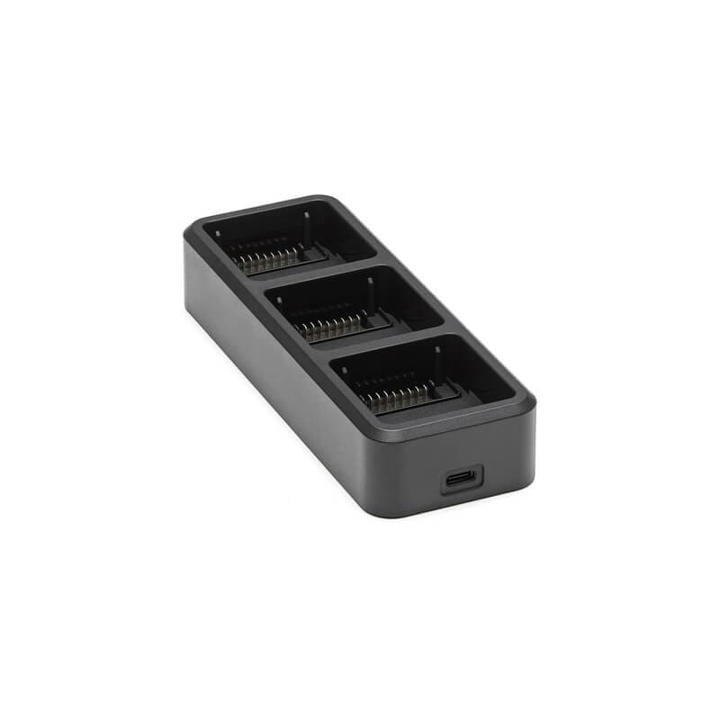 Black battery charger with four slots on a white background