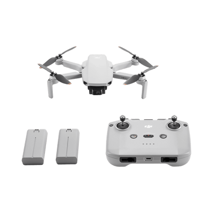 DJI Mini 2 SE White drone with remote control and batteries on a black background