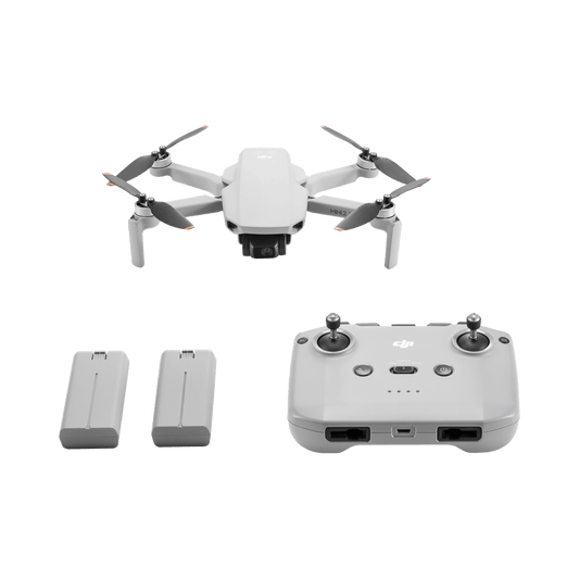DJI Mini 2 SE White drone with remote control and batteries on a black background