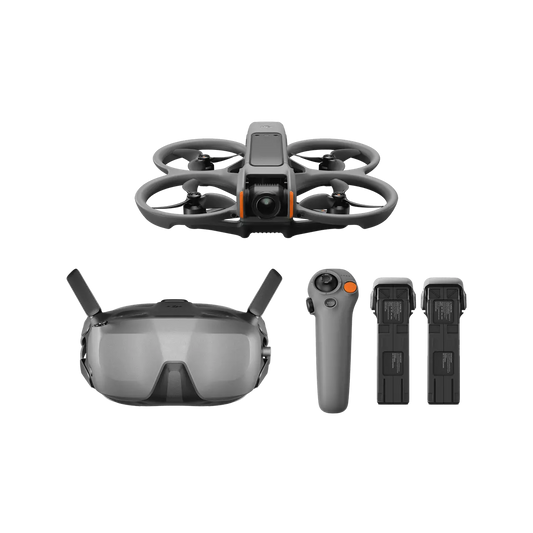 Drone with goggles, remote control, and batteries on a white background