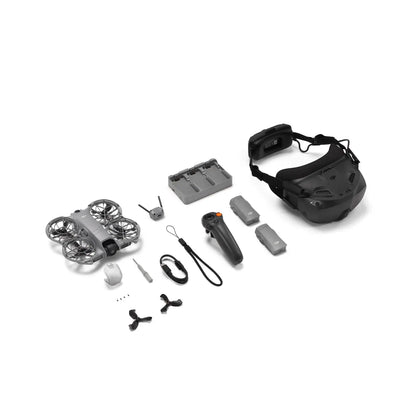 Collection of drone components including a drone, remote control, and goggles on a white background