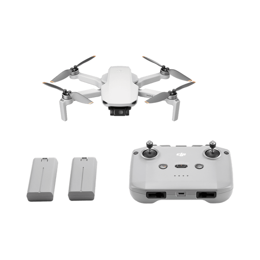 DJI mini 4K fly more combo White drone with remote control and batteries on a black background