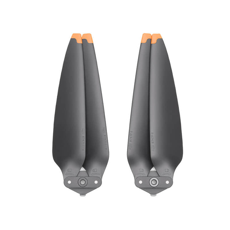 Two black helicopter propellers with orange tips on a white background
