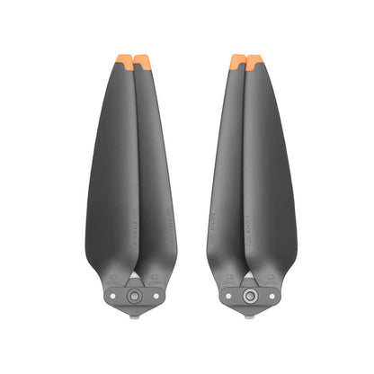 Two black helicopter propellers with orange tips on a white background