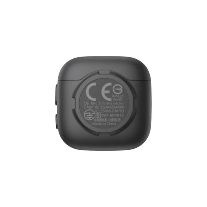 Black DJI Mic 3 transmitter device with certification logos on a white background