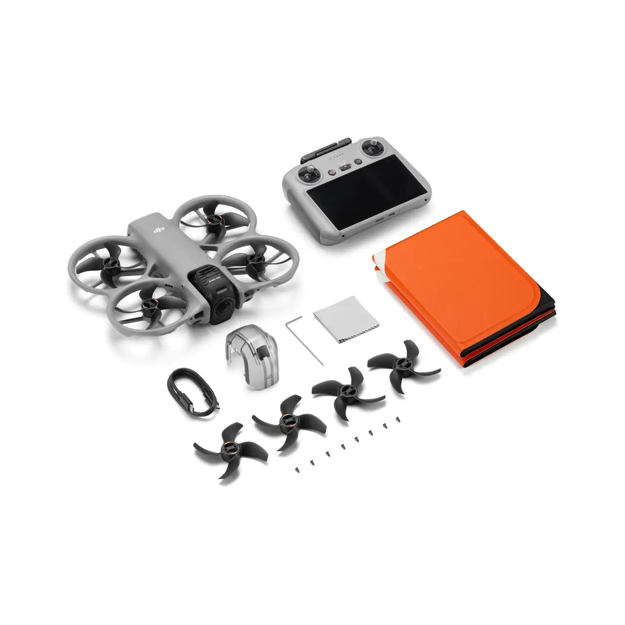 Drone kit with drone, controller, propellers, and accessories on a white background