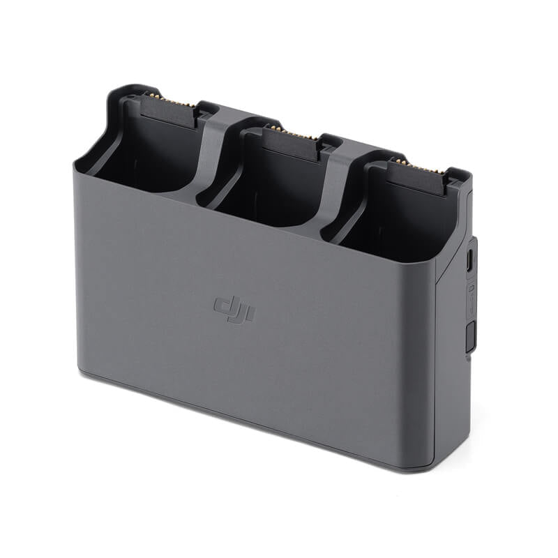 Black battery charger for multiple batteries on a white background