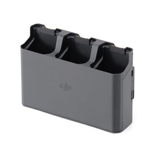 Black battery charger for multiple batteries on a white background