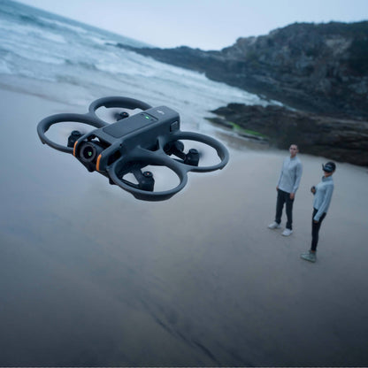 Drone flying over a beach with two people watching