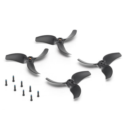 Set of black drone propellers with small screws on a white background