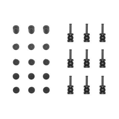 Set of black cylindrical and round objects on a black background