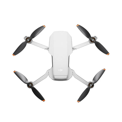 DJI Mini 2 SE drone with four propellers on a white background