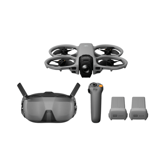 Drone with goggles, remote control, and batteries on a black background