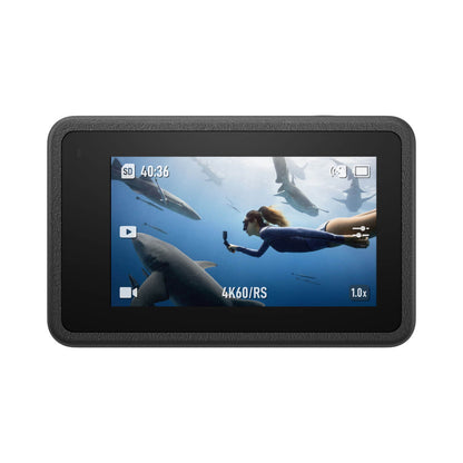 Display of a digital camera screen showing underwater footage with a person and shark.