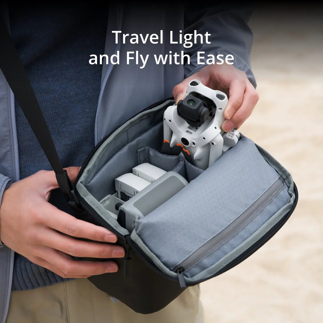 Person holding a compact camera and carrying case with text 'Travel Light and Fly with Ease'.