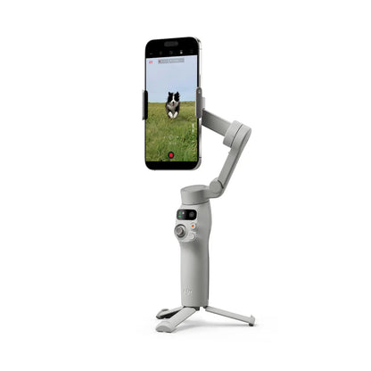 Smartphone mounted on a DJI Osmo Mobile 7 Smartphone Gimbal with a dog in a field displayed on the screen, on a white background