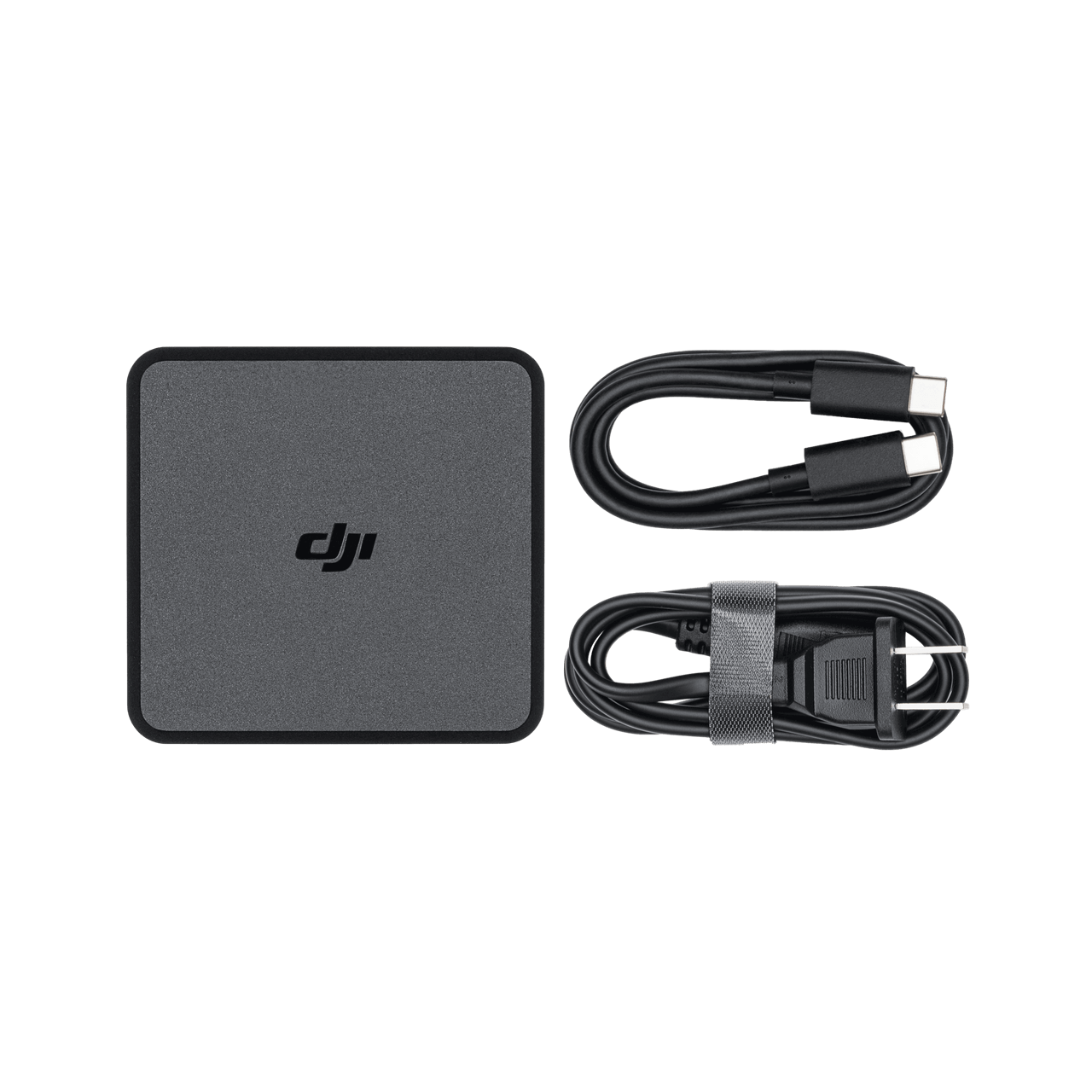 DJI power adapter and cables on a black background