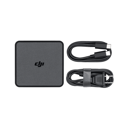 DJI power adapter and cables on a black background