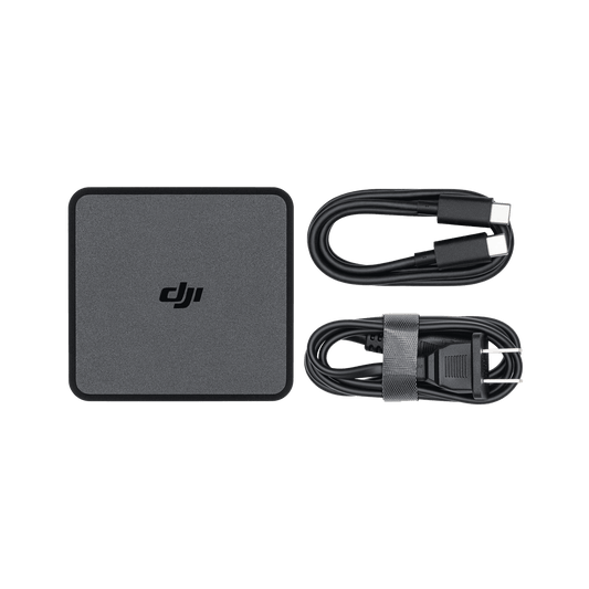 DJI power adapter and cables on a black background