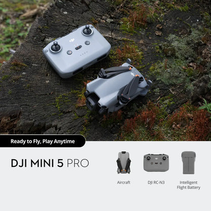 DJI Mini 5 Pro drone on a wooden surface with packaging and accessories.