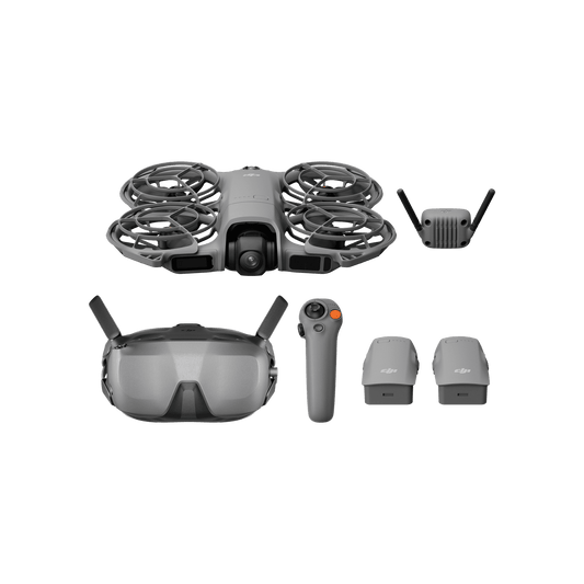 Collection of drone components including a drone, goggles, remote control, and accessories on a black background.