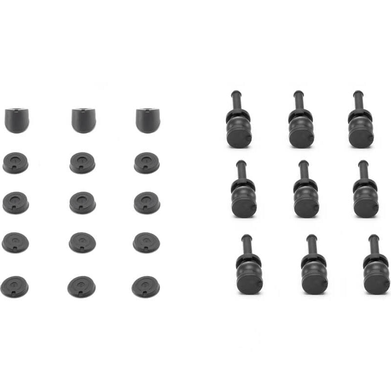 Set of black rubber grommets arranged in a grid on a white background