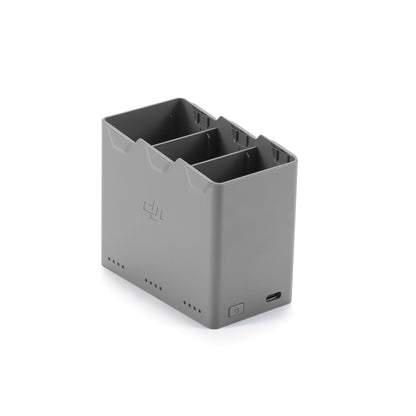 Gray battery charger with two slots on a white background