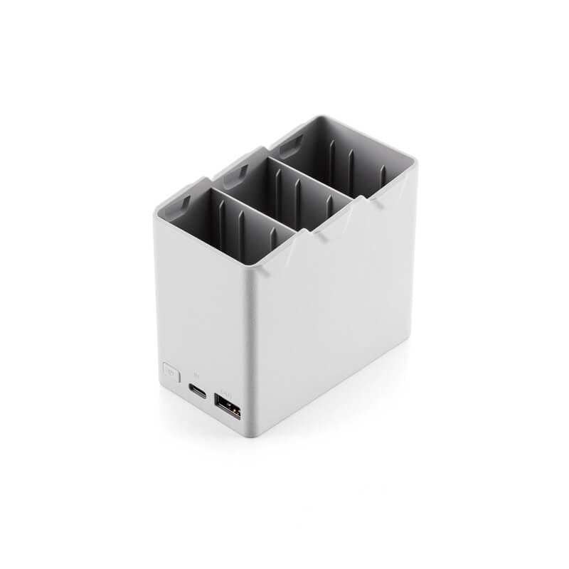 Small gray electronic device with ports on a white background