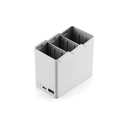 Small gray electronic device with ports on a white background