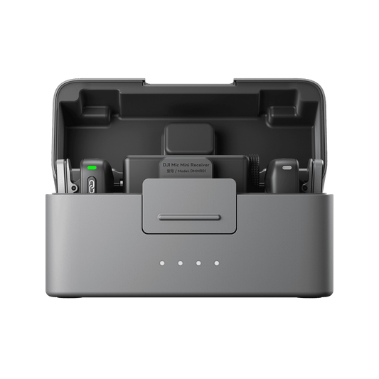 Gray DJI Mic Mini electronic device with components inside on a black background