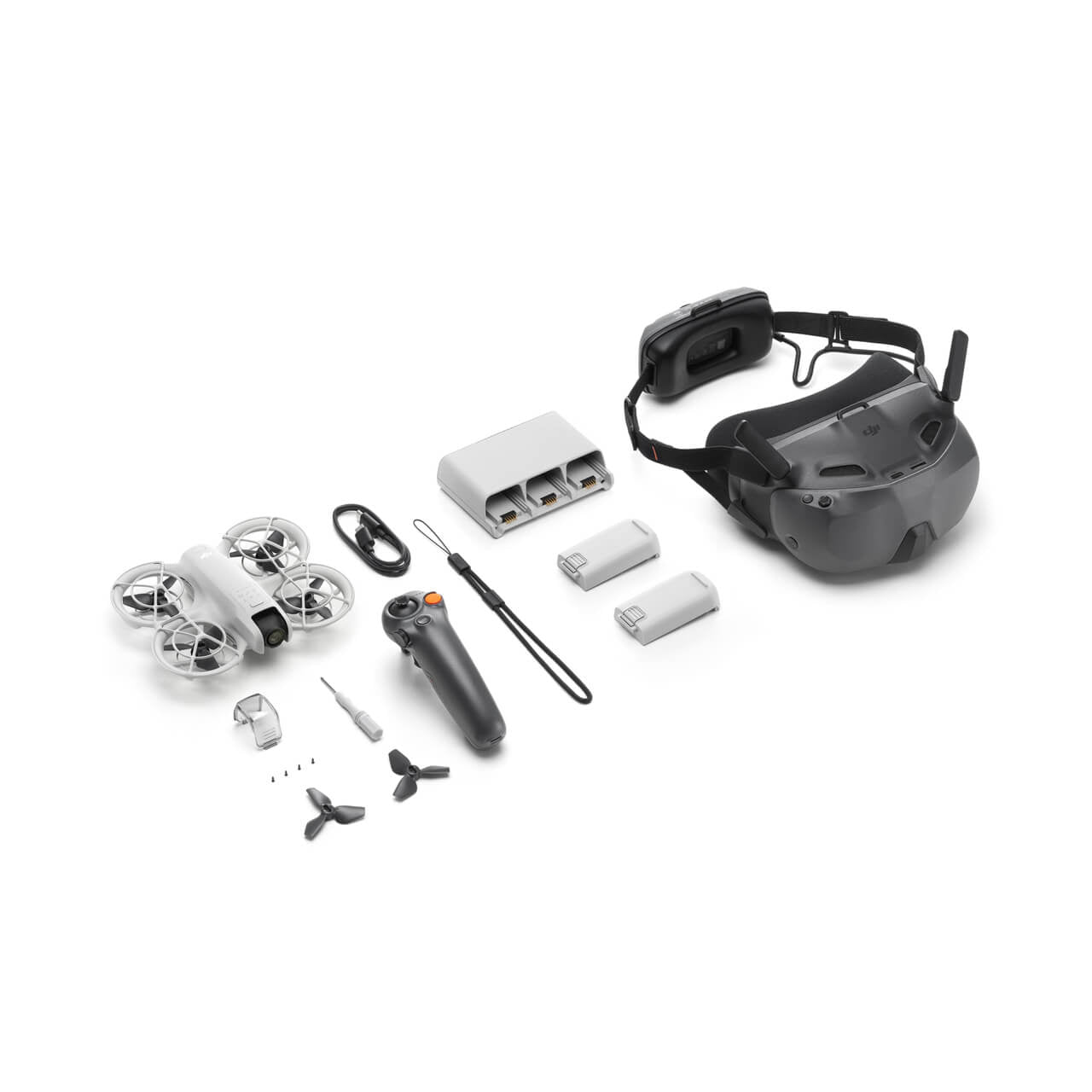 Collection of DJI Neo Motion drone parts including a helmet, remote control, and components on a white background