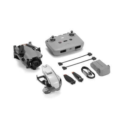 Collection of drone parts including body, controller, propellers, and battery on a white background