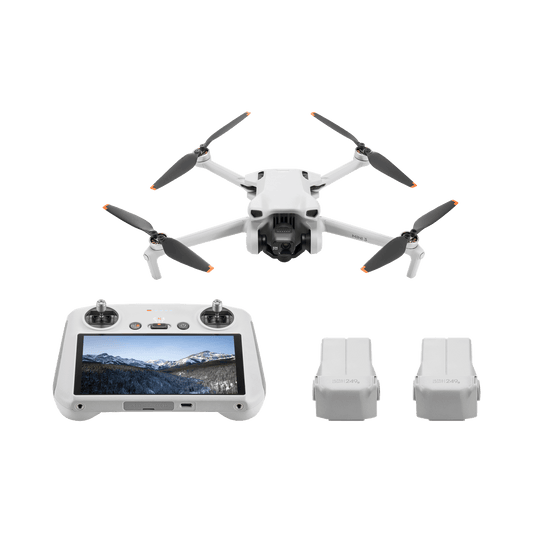 DJI mini 3 White drone with remote control and batteries on a black background