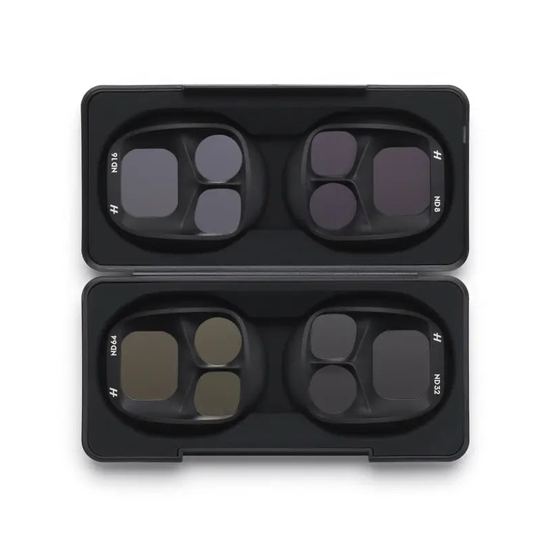 Four camera lens filters in a black case on a white background