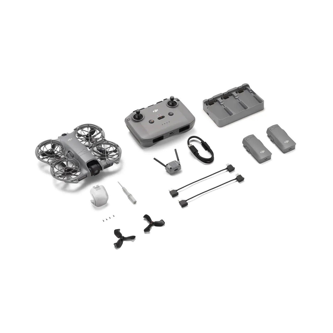 Collection of drone components including drone, controller, battery, and accessories on a white background