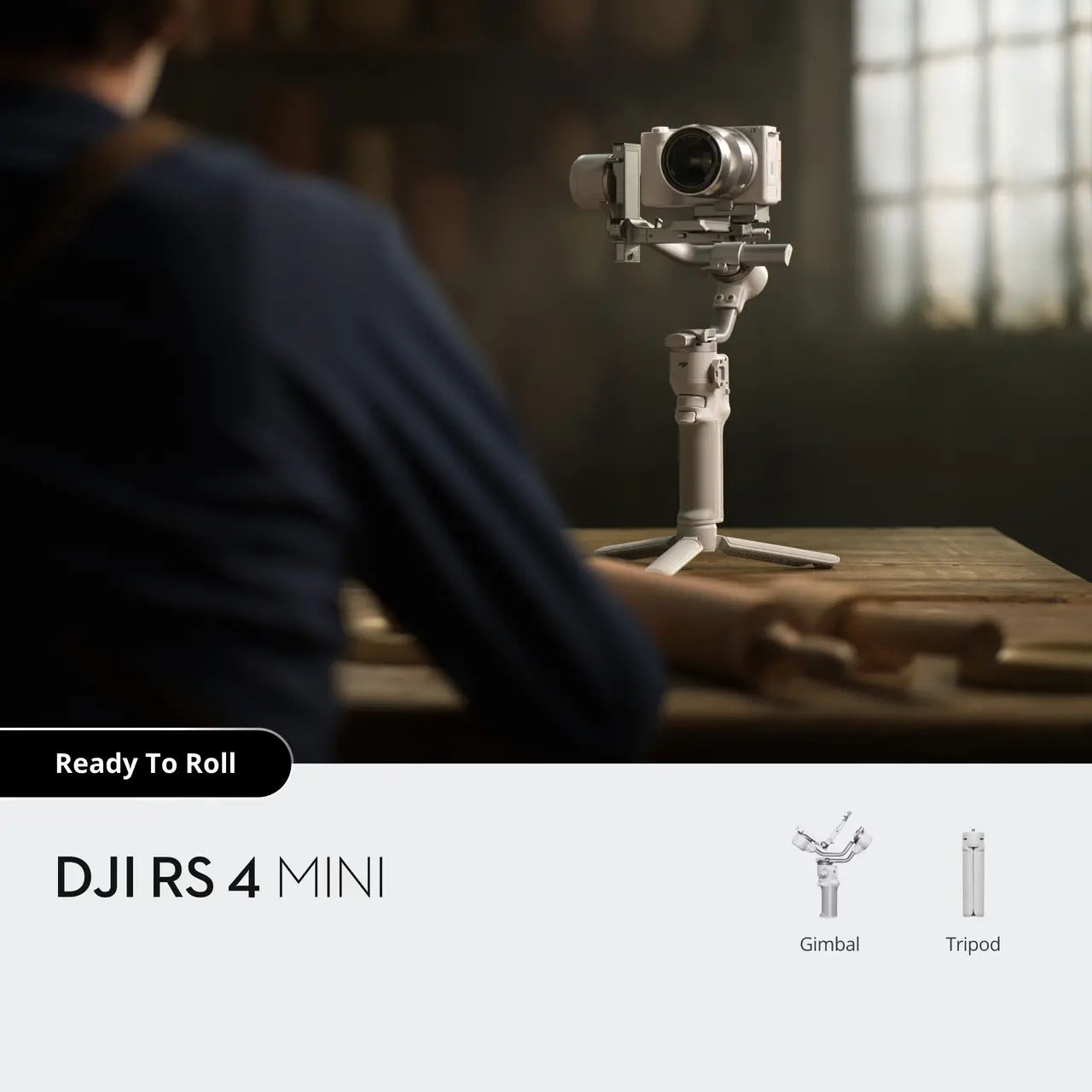 DJI RS 4 Mini camera on a stand with a person in the background, in a warm-toned room.