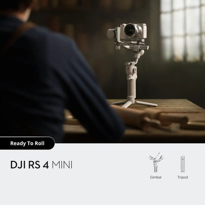 DJI RS 4 Mini camera on a stand with a person in the background, in a warm-toned room.