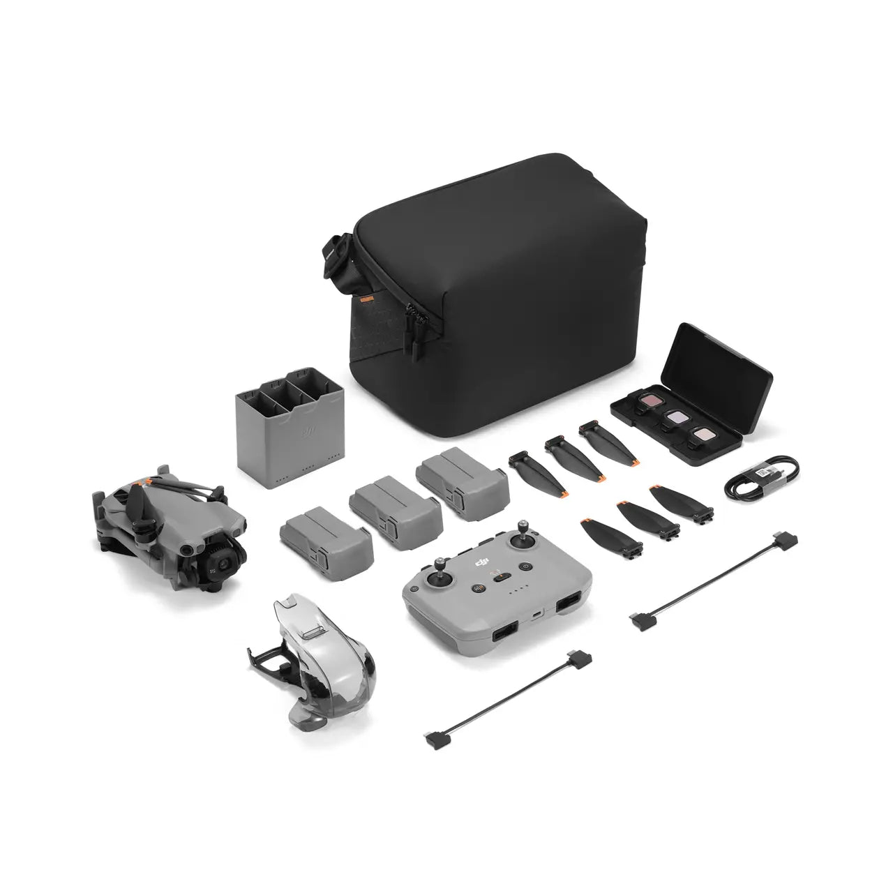 Collection of drone accessories including a black carrying case on a white background